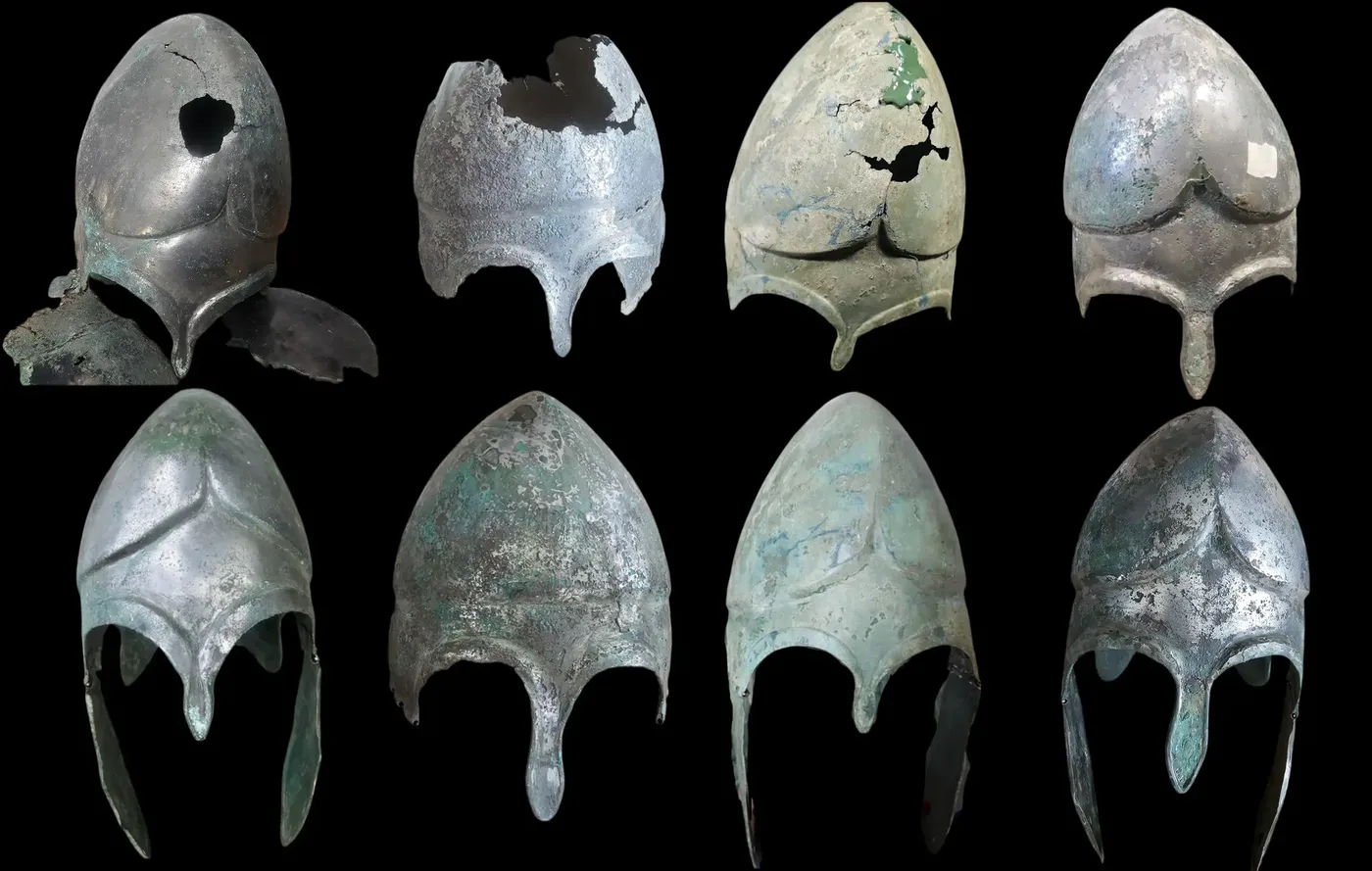 Eight ancient bronze helmets with different states of preservation and reconstruction limits